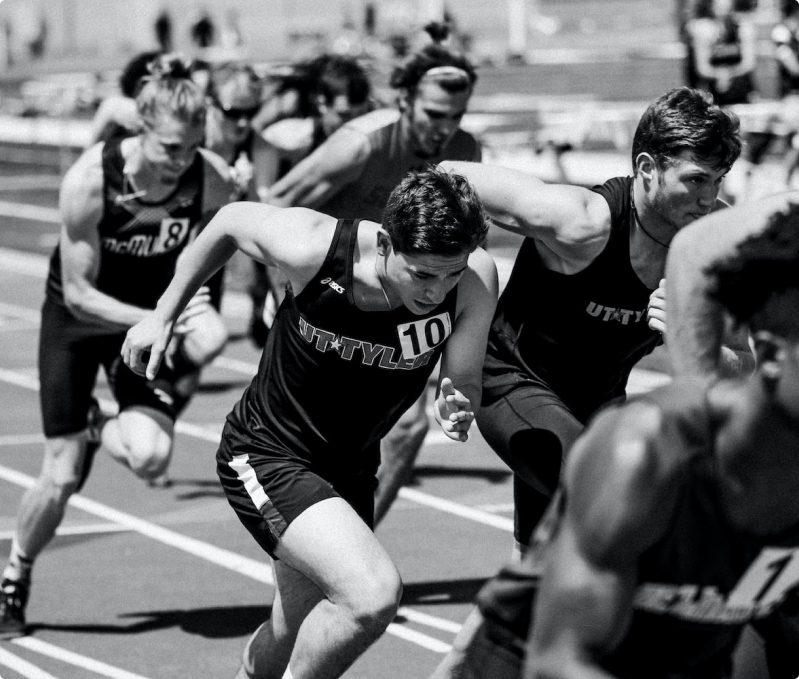 Black and white photo of runners engaged in a race.